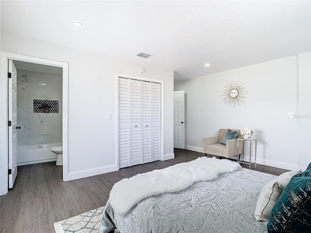 bedroom featuring a closet, wood finished floors, visible vents, and baseboards