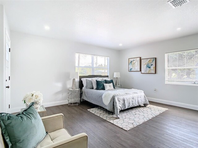 bedroom featuring recessed lighting, dark wood finished floors, visible vents, and baseboards