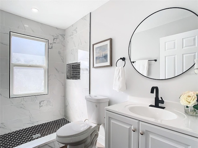 full bath with a stall shower, marble finish floor, vanity, and toilet