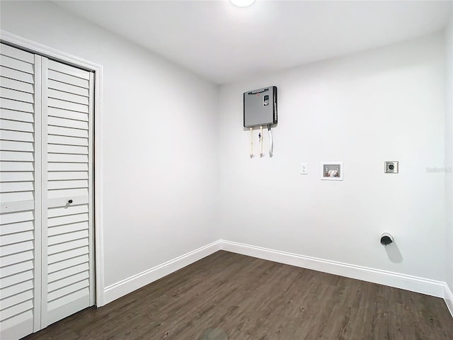 clothes washing area featuring dark wood-style floors, hookup for a washing machine, electric dryer hookup, laundry area, and baseboards