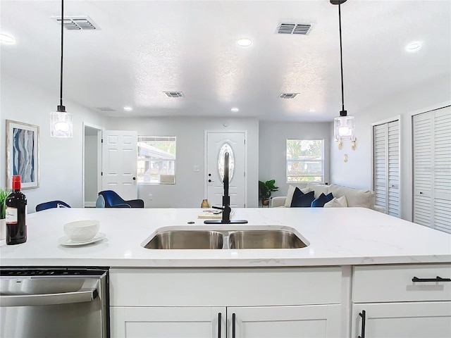 kitchen featuring open floor plan, visible vents, and stainless steel dishwasher