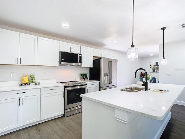 kitchen featuring white cabinets, stainless steel appliances, a sink, and wood finished floors