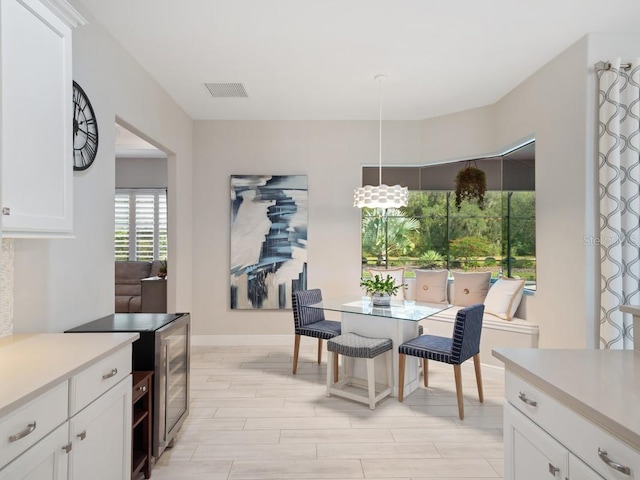 dining area featuring wood finish floors, visible vents, and baseboards