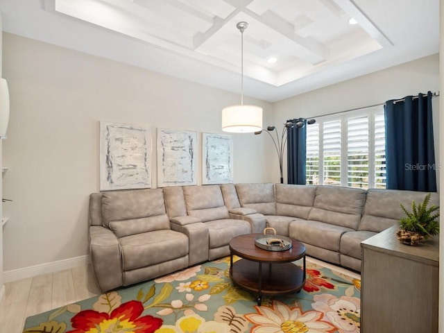 living area with beam ceiling, baseboards, coffered ceiling, and wood finished floors