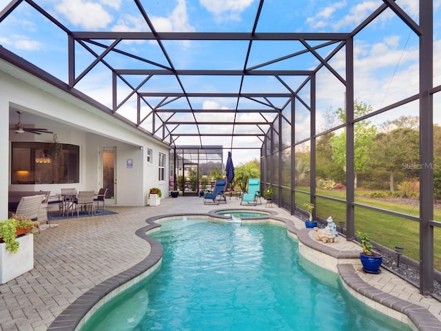 view of swimming pool with a patio, glass enclosure, ceiling fan, outdoor dining area, and a pool with connected hot tub