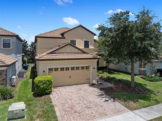 view of front of house featuring a garage, decorative driveway, a tile roof, and stucco siding