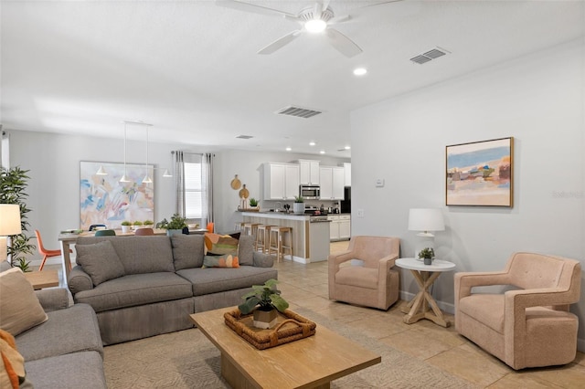 living area with light tile patterned floors, visible vents, a ceiling fan, and recessed lighting