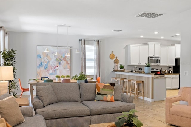 living area with recessed lighting, visible vents, baseboards, and light tile patterned flooring