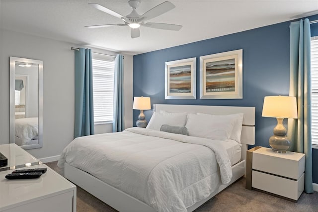 carpeted bedroom featuring a ceiling fan and baseboards