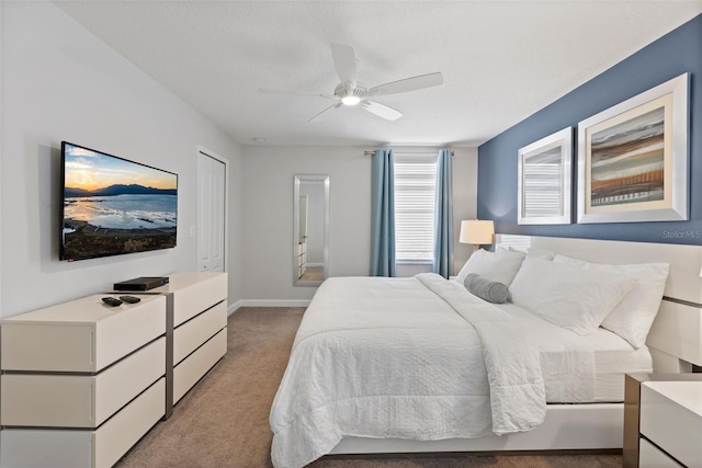 bedroom with light carpet, ceiling fan, and baseboards