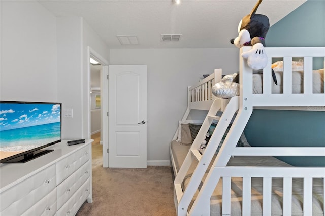 carpeted bedroom featuring visible vents and baseboards