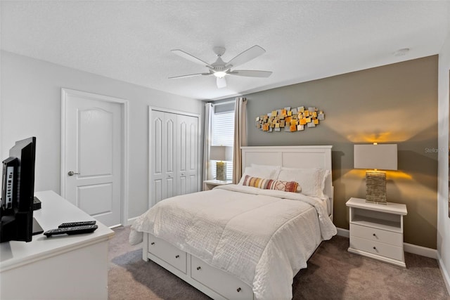 bedroom featuring a textured ceiling, ceiling fan, baseboards, a closet, and carpet