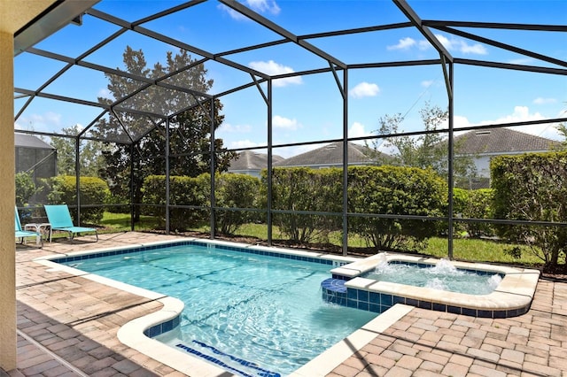 view of pool with glass enclosure, a patio area, and a pool with connected hot tub