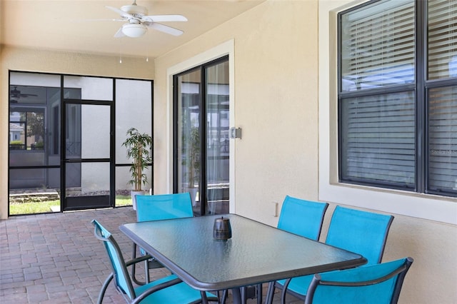 view of patio with outdoor dining space and a ceiling fan