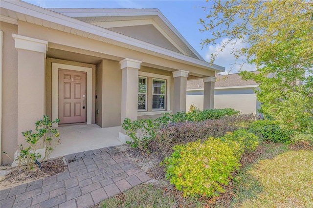 property entrance with stucco siding