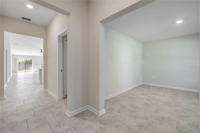 hallway with recessed lighting, visible vents, and baseboards