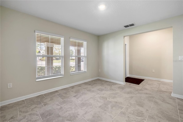 empty room featuring visible vents and baseboards