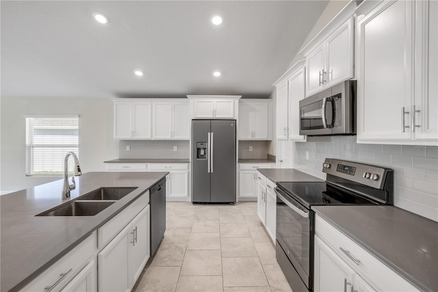 kitchen featuring appliances with stainless steel finishes, a sink, and white cabinetry