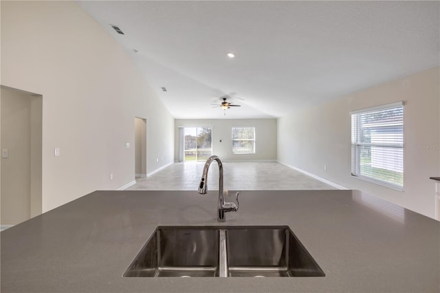 kitchen with visible vents, open floor plan, a sink, ceiling fan, and high vaulted ceiling