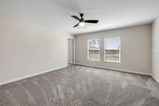 carpeted spare room featuring a ceiling fan, baseboards, and a textured ceiling