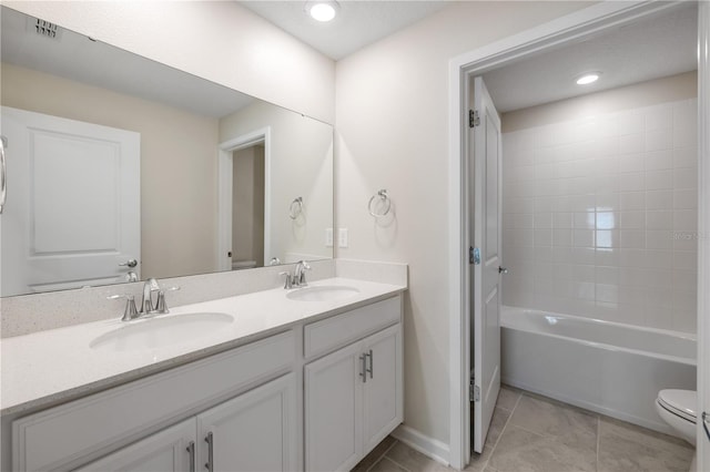 full bath featuring double vanity, tile patterned flooring, a sink, and toilet