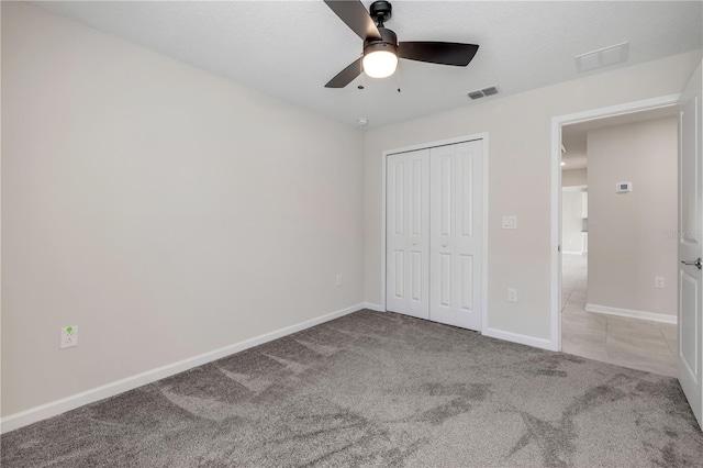 unfurnished bedroom featuring a closet, carpet, visible vents, and baseboards