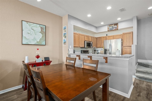 dining area with recessed lighting, dark wood-type flooring, visible vents, baseboards, and stairway