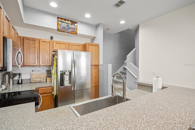 kitchen featuring recessed lighting, light countertops, visible vents, appliances with stainless steel finishes, and a sink