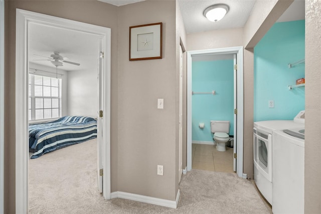 laundry room with ceiling fan, carpet floors, separate washer and dryer, laundry area, and baseboards