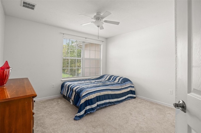 bedroom with a ceiling fan, carpet, visible vents, and baseboards