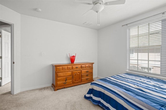 carpeted bedroom featuring ceiling fan, visible vents, and baseboards