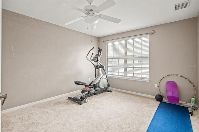 exercise room featuring a ceiling fan, carpet, visible vents, and baseboards