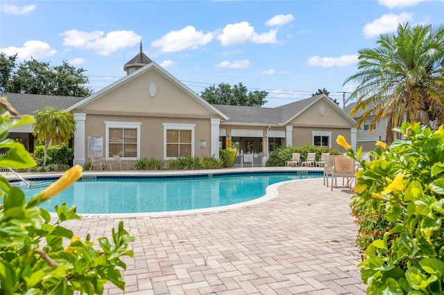 community pool with a patio area