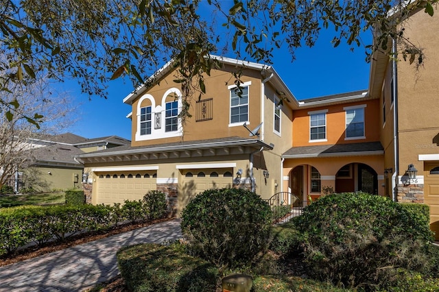 view of front of home with an attached garage and stucco siding