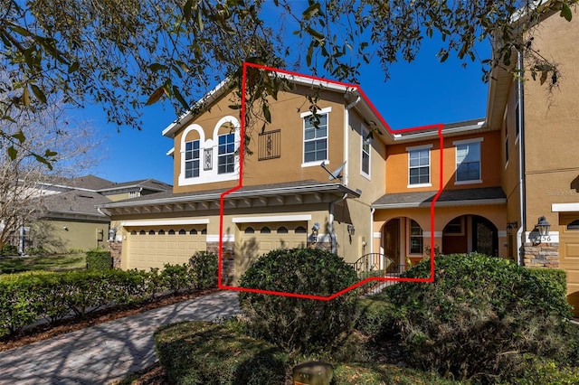 view of front facade with an attached garage and stucco siding