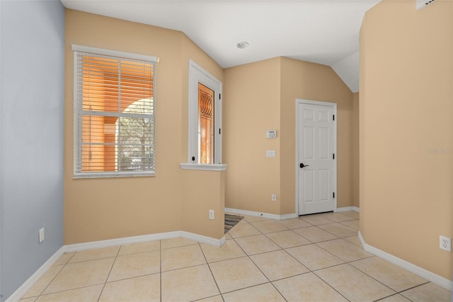 interior space featuring baseboards and vaulted ceiling