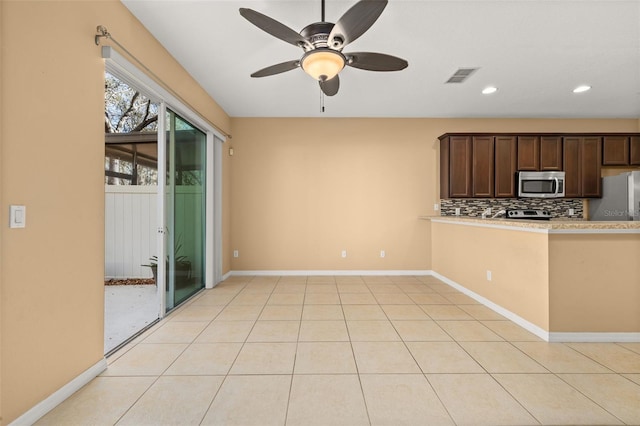 kitchen featuring light tile patterned floors, visible vents, appliances with stainless steel finishes, and backsplash