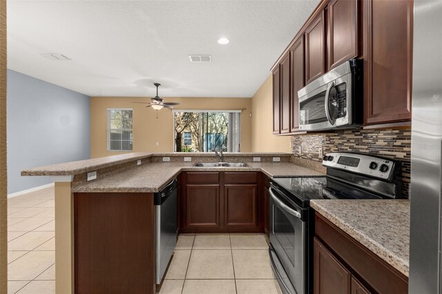 kitchen featuring appliances with stainless steel finishes, visible vents, a sink, and light tile patterned floors