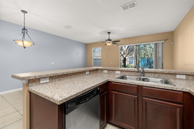 kitchen featuring a sink, visible vents, light countertops, stainless steel dishwasher, and pendant lighting