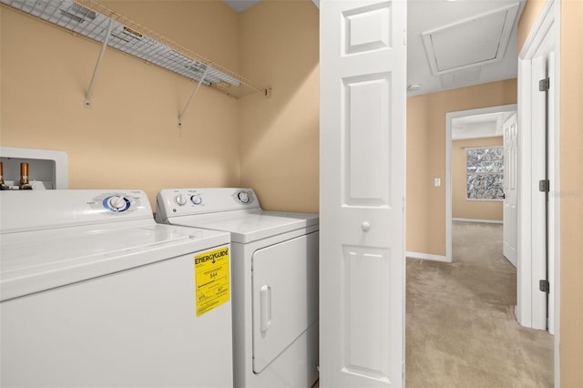 laundry room with washer and dryer, laundry area, light colored carpet, and baseboards