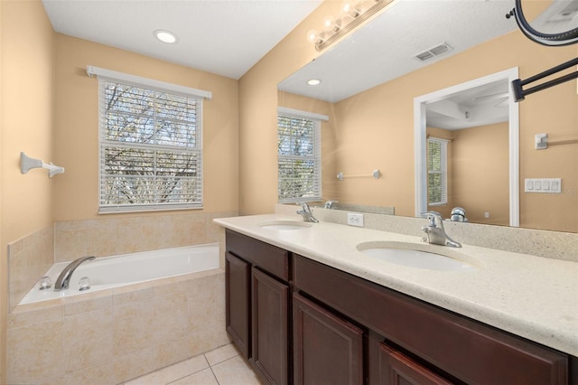 full bathroom with visible vents, a sink, a garden tub, and tile patterned floors