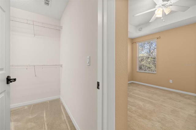 walk in closet featuring carpet floors, ceiling fan, and visible vents