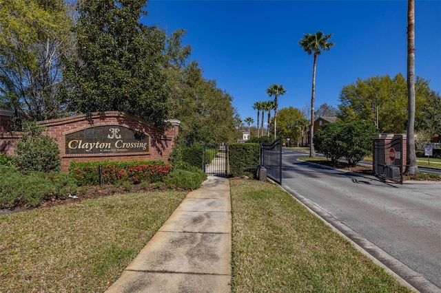 community / neighborhood sign with a gate