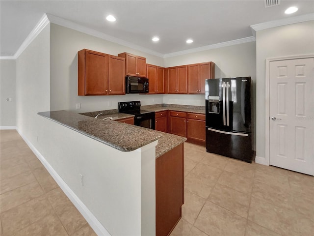 kitchen with brown cabinets, ornamental molding, dark stone countertops, a peninsula, and black appliances