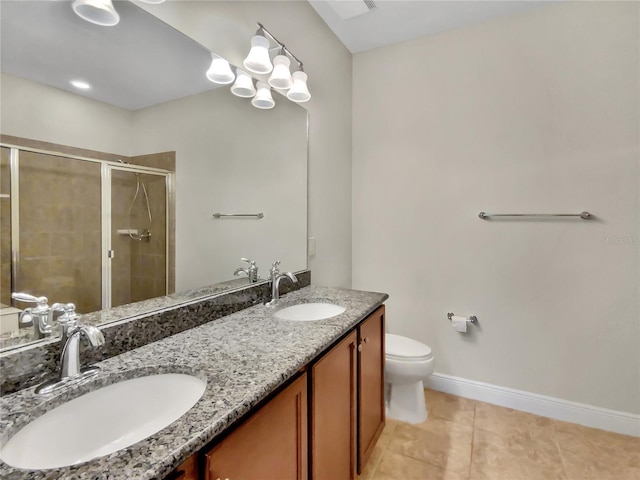 bathroom with a stall shower, toilet, a sink, and baseboards