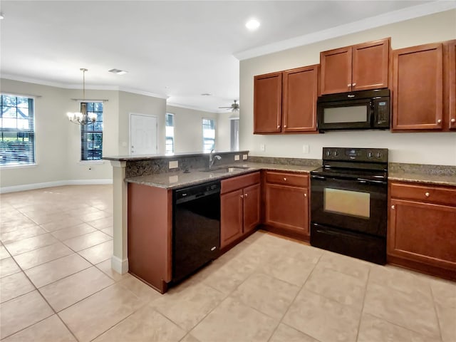 kitchen featuring a sink, black appliances, a healthy amount of sunlight, and crown molding