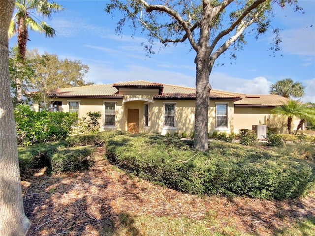 mediterranean / spanish house with stucco siding and a tiled roof