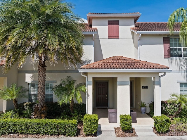 view of front of property featuring a tile roof and stucco siding