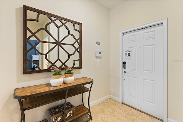 entrance foyer with baseboards and light tile patterned flooring