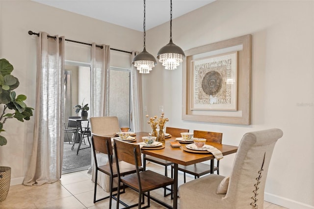 dining room featuring baseboards and light tile patterned flooring